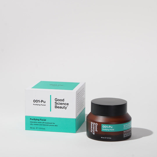 Frosted amber glass bottle and cardboard display box of 001-Pu Purifying Facial against light grey background