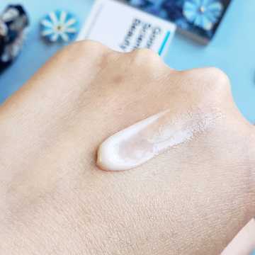 003-Hy Hydrating Face Cream pea sized drop smeared on the back of a hand