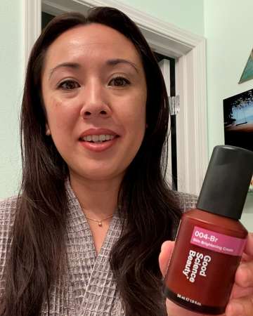Customer Tiffany C holds bottle of 004-Br Skin Brightening Cream into camera