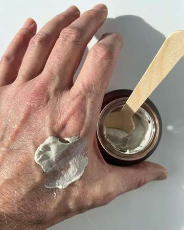 001-Pu Facial mask texture smeared on the back of a man's hand on white background