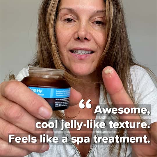 Michele B. has a jar of 003-Hy Hydrating Facial in her right hand and a dab of the facial on the finger of her left hand. Quote in caption: 